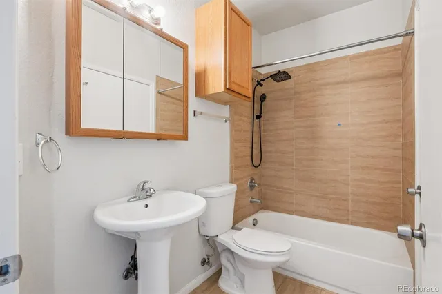 a bathroom with a sink a toilet and a bathtub