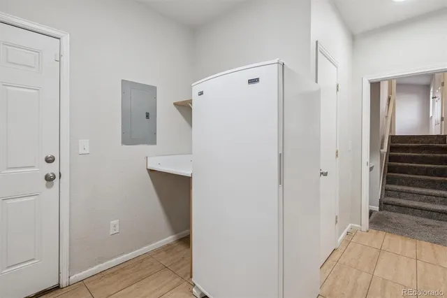 a view of a hallway with wooden floor and cabinets