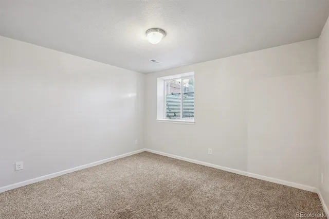 an empty room with a empty space and windows