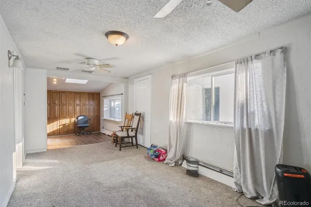 a view of a livingroom with workspace and a window