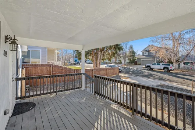 a view of a porch with wooden floor and outdoor seating