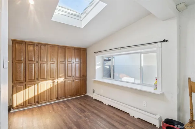 a view of wooden floor and brick walls