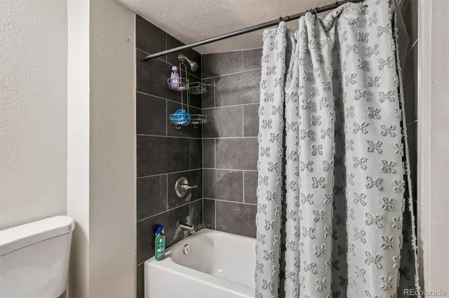 a bathroom with a bathtub and shower