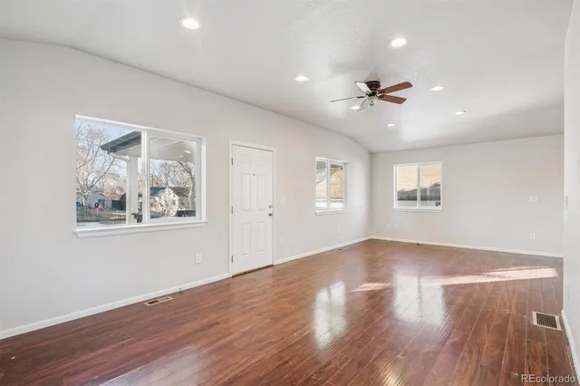 wooden floor in an empty room with a window