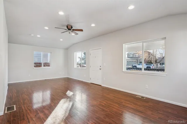 wooden floor in an empty room with a window