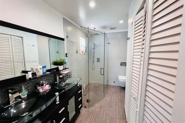 a view of a hallway and a livingroom with furniture