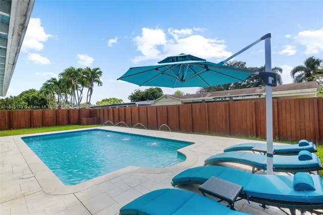 a swimming pool with an outdoor seating