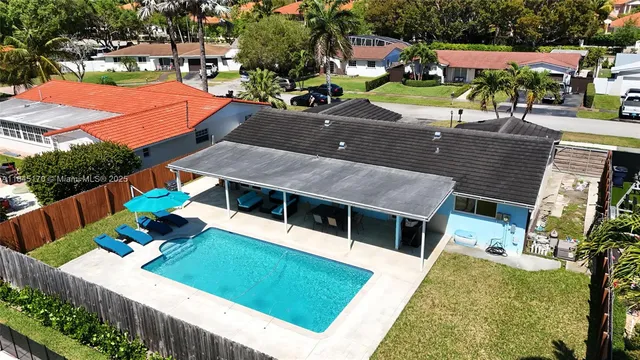 an aerial view of a house with a yard
