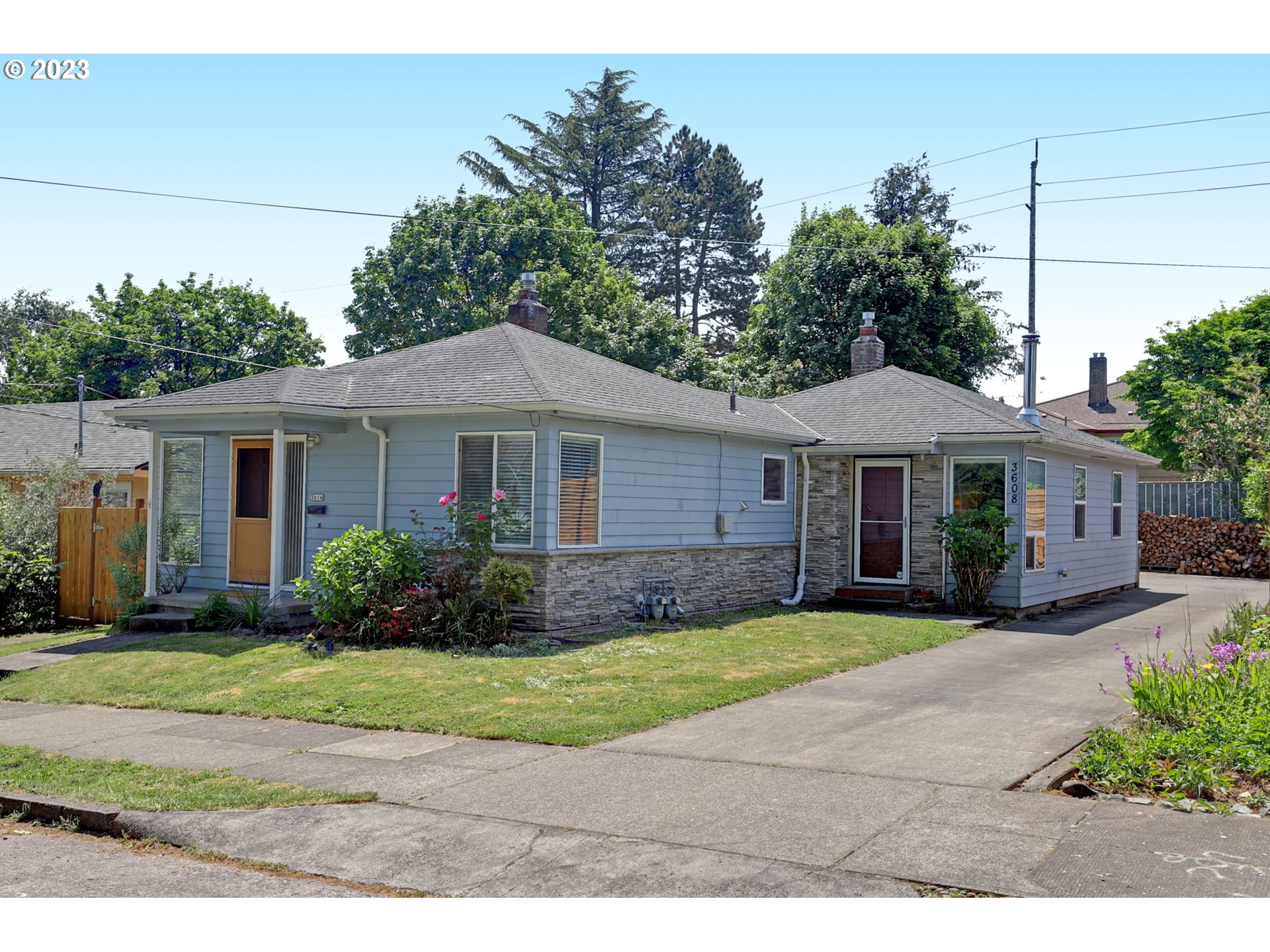 3608 Southeast Center Street Portland, OR 97202 - Photo 1 of 27 a front view of a house with a garden and yard