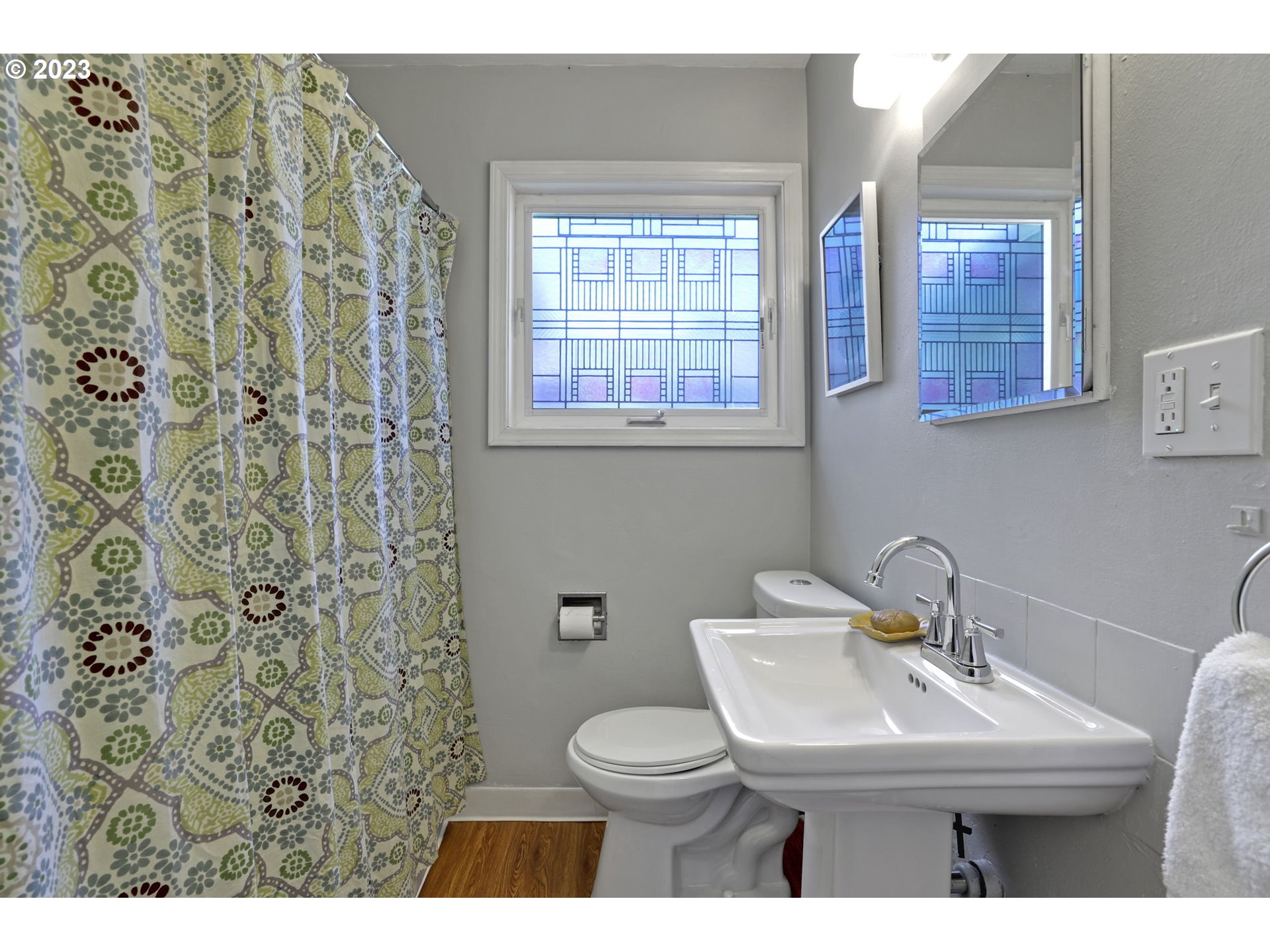 3608 Southeast Center Street Portland, OR 97202 - Photo 11 of 27 a bathroom with a sink a toilet and a mirror