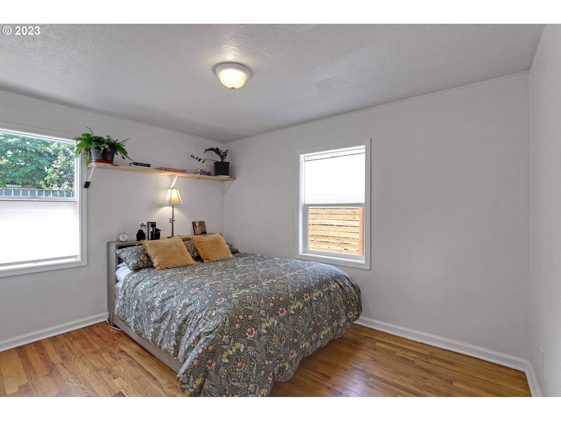 3608 Southeast Center Street Portland, OR 97202 - Photo 21 of 27 a bedroom with a bed and a window