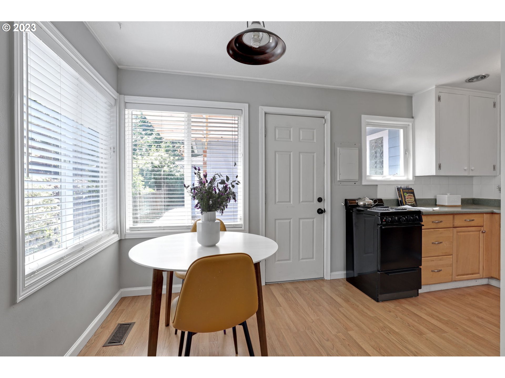 3608 Southeast Center Street Portland, OR 97202 - Photo 5 of 27 a kitchen with granite countertop a sink dining table and chairs