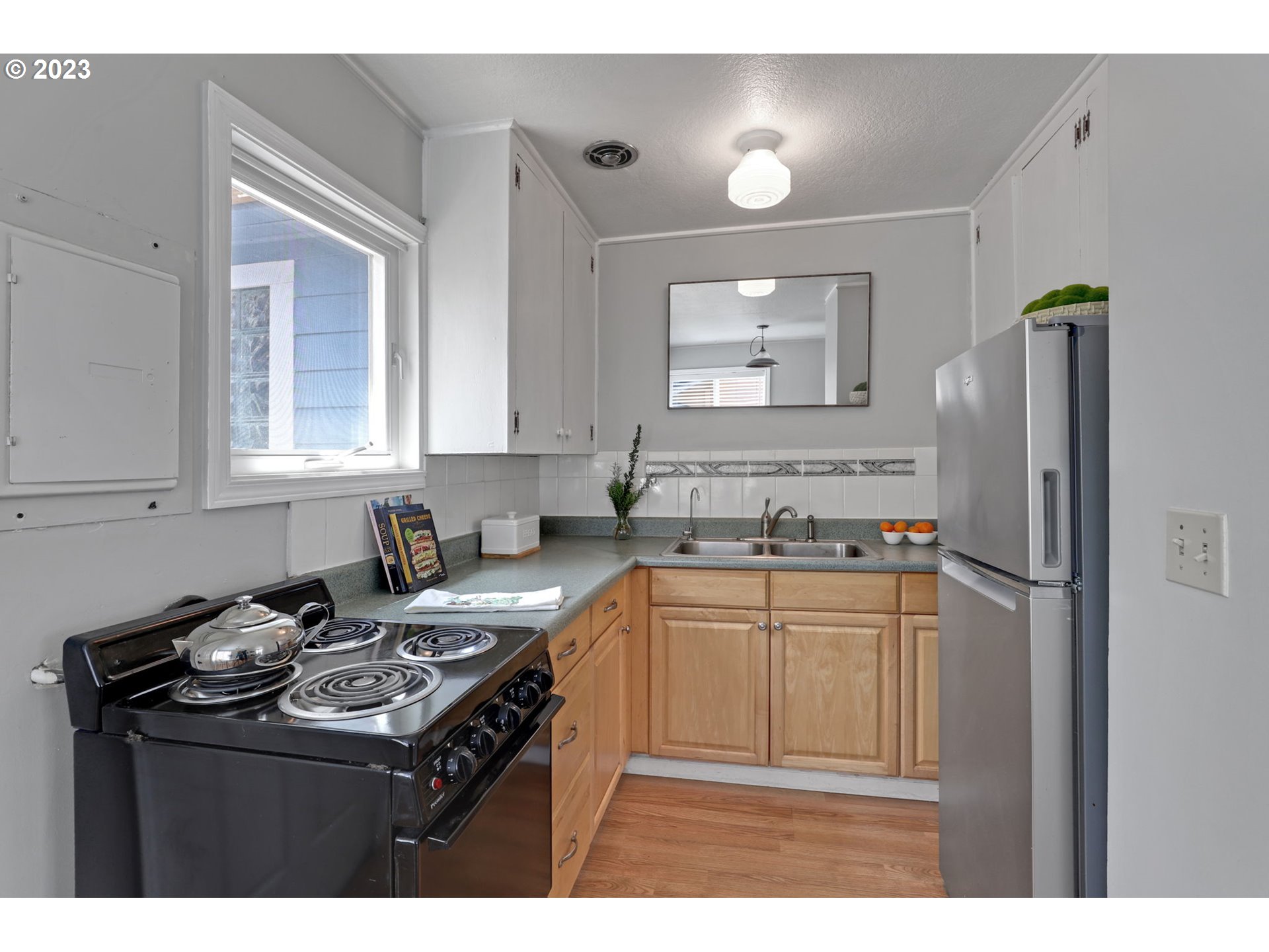 3608 Southeast Center Street Portland, OR 97202 - Photo 8 of 27 a kitchen with stainless steel appliances granite countertop a sink stove and refrigerator