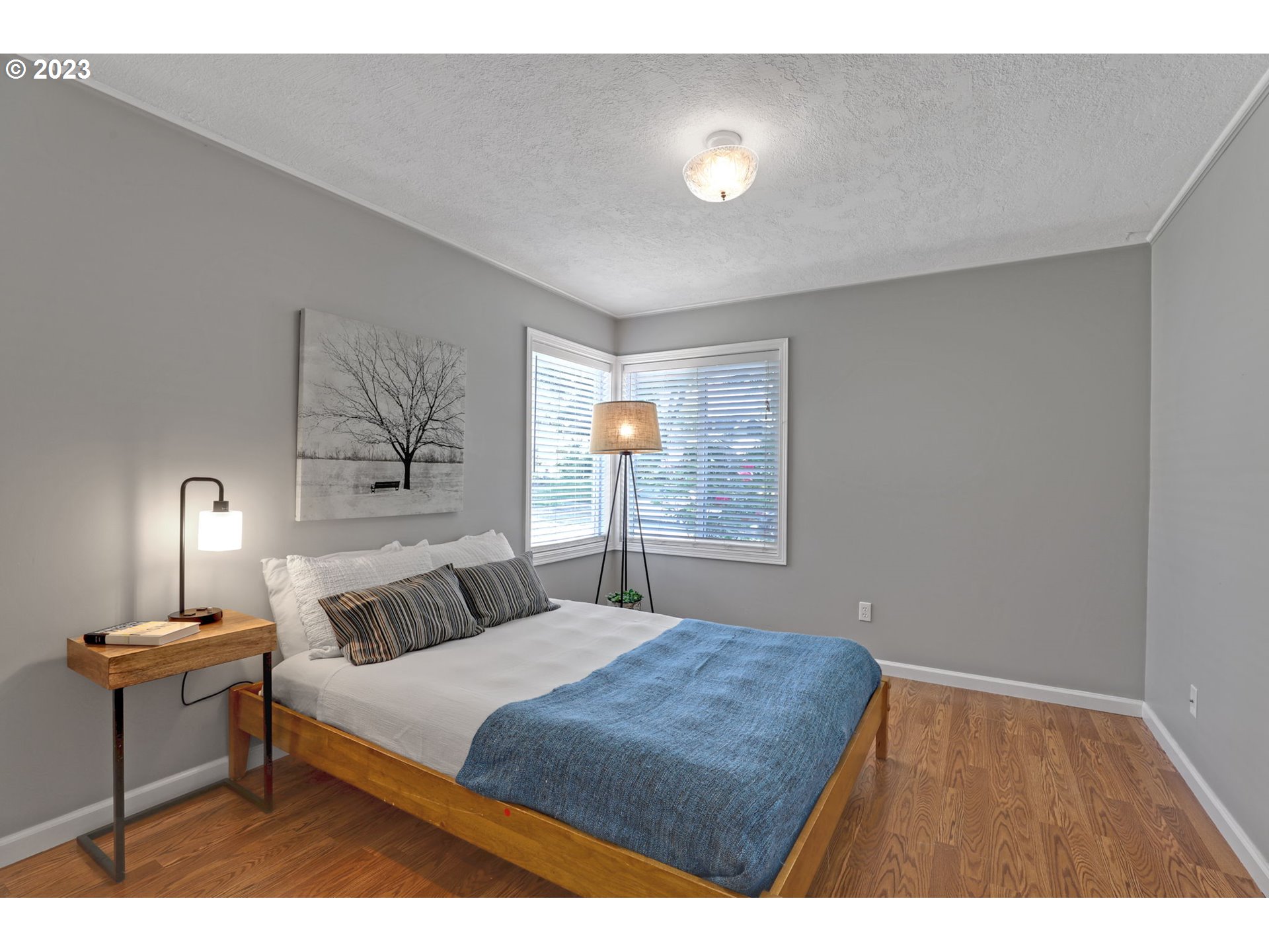 3608 Southeast Center Street Portland, OR 97202 - Photo 9 of 27 a bedroom with a bed and a table
