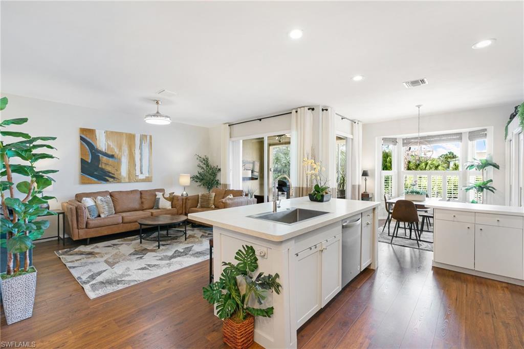 a large white kitchen with a large window