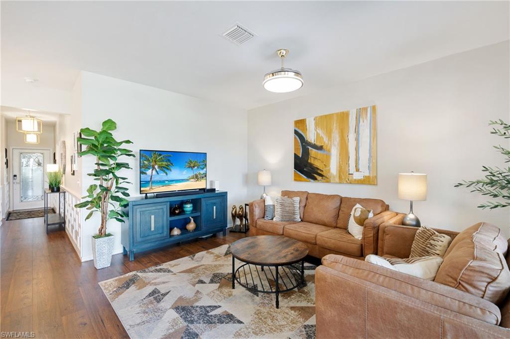 21445 Knighton Run Estero, FL 33928 - Photo 17 of 48 a living room with furniture and a flat screen tv
