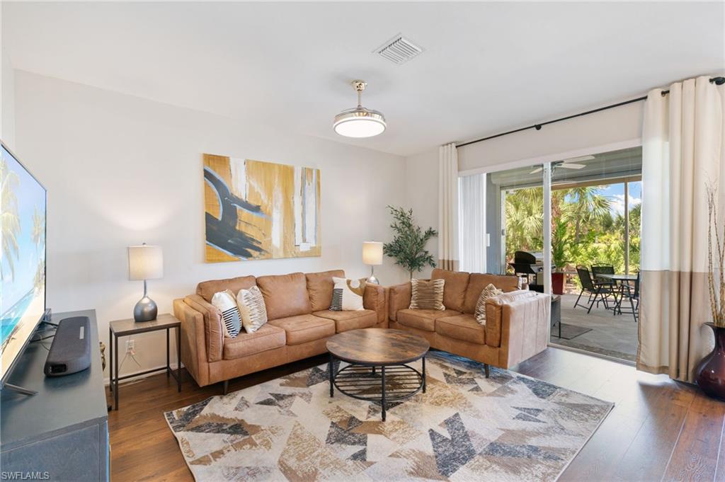 21445 Knighton Run Estero, FL 33928 - Photo 18 of 48 a living room with furniture and a large window