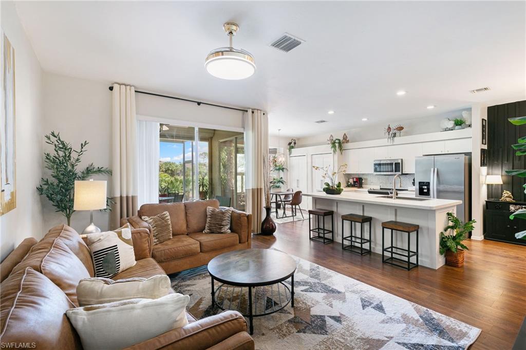 21445 Knighton Run Estero, FL 33928 - Photo 20 of 48 a living room with furniture and a wooden floor