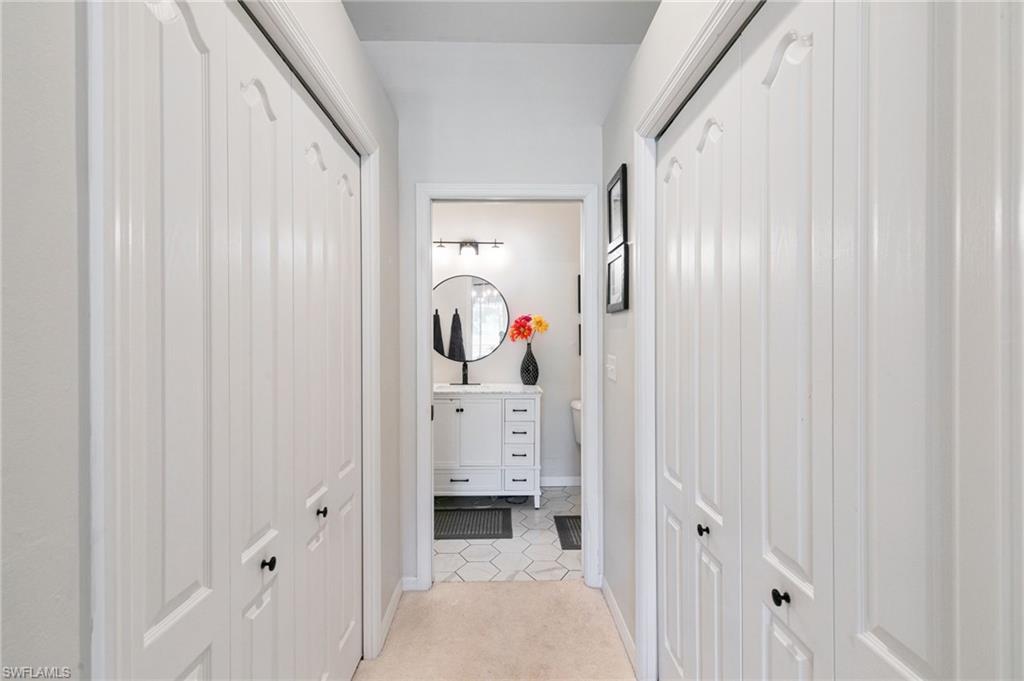 21445 Knighton Run Estero, FL 33928 - Photo 22 of 48 a view of a hallway with washer and dryer