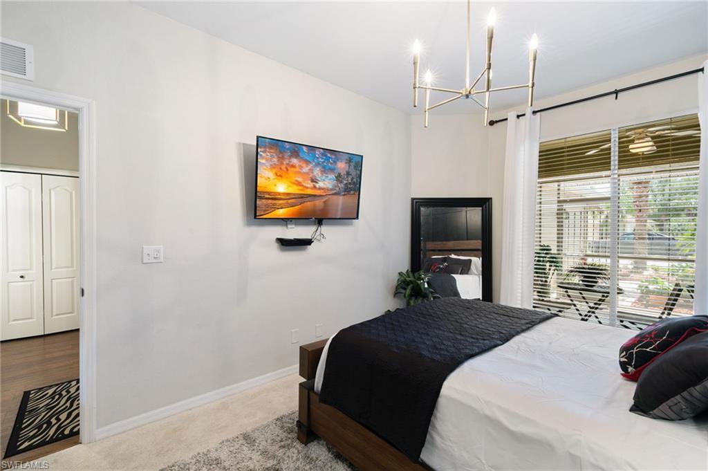 21445 Knighton Run Estero, FL 33928 - Photo 26 of 48 a bedroom with a bed and a flat screen tv
