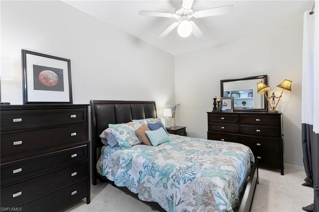21445 Knighton Run Estero, FL 33928 - Photo 28 of 48 a bedroom with a bed and a lamp on dresser