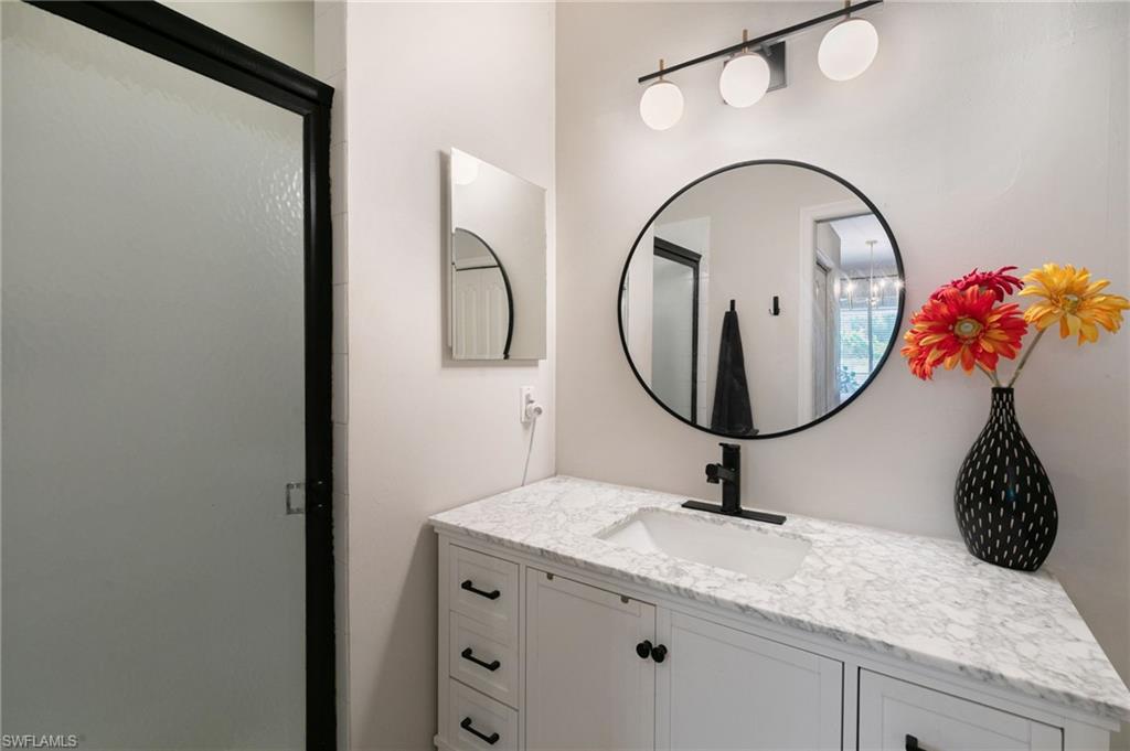 21445 Knighton Run Estero, FL 33928 - Photo 30 of 48 a bathroom with a sink and a mirror
