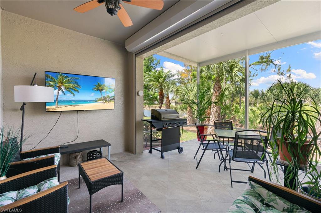 21445 Knighton Run Estero, FL 33928 - Photo 32 of 48 a living room with furniture a rug and a large window