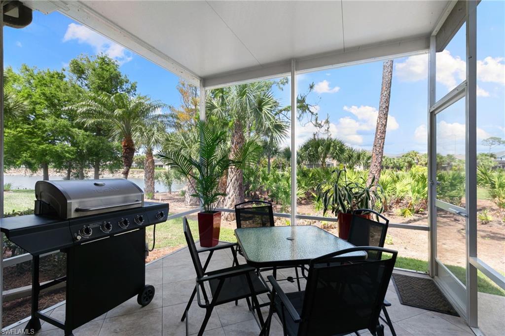 21445 Knighton Run Estero, FL 33928 - Photo 33 of 48 a dining room with furniture and a floor to ceiling window