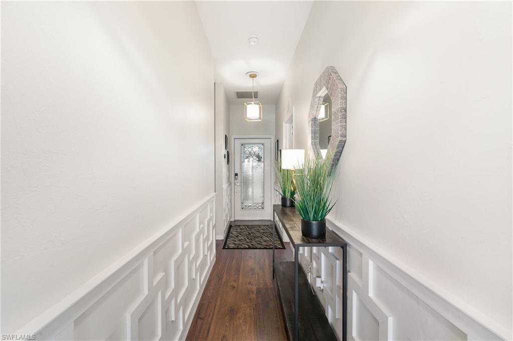 21445 Knighton Run Estero, FL 33928 - Photo 6 of 48 a view of a hallway with wooden floor