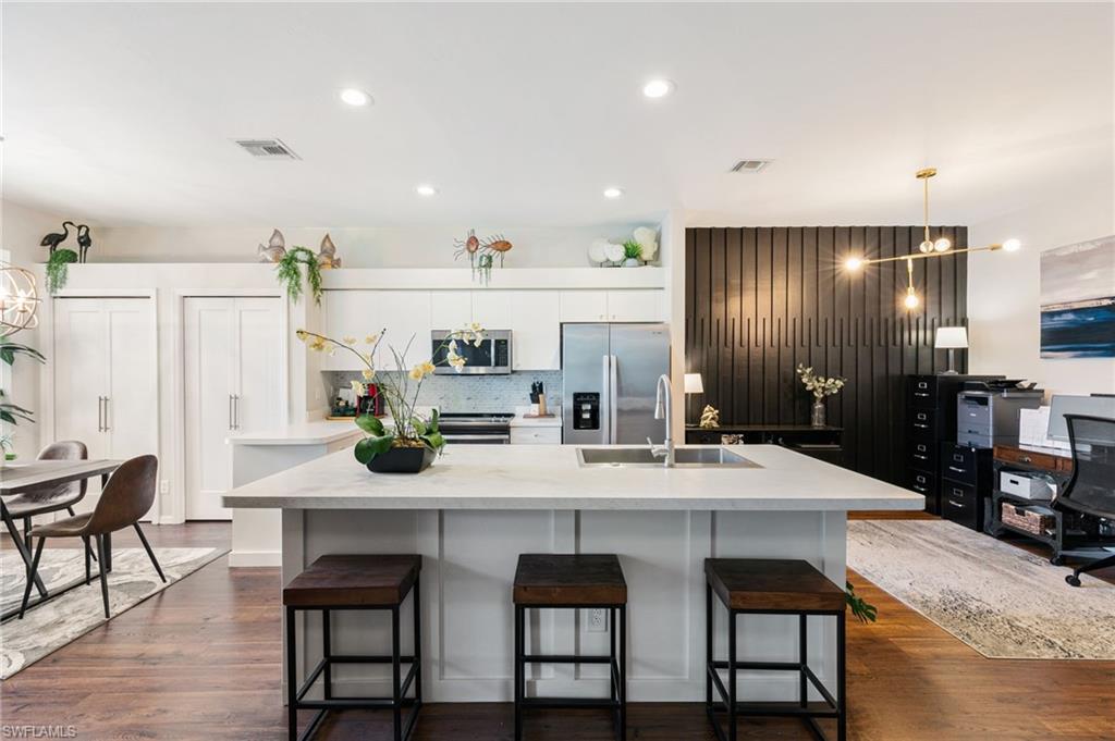 21445 Knighton Run Estero, FL 33928 - Photo 8 of 48 a kitchen with granite countertop a table and chairs in it