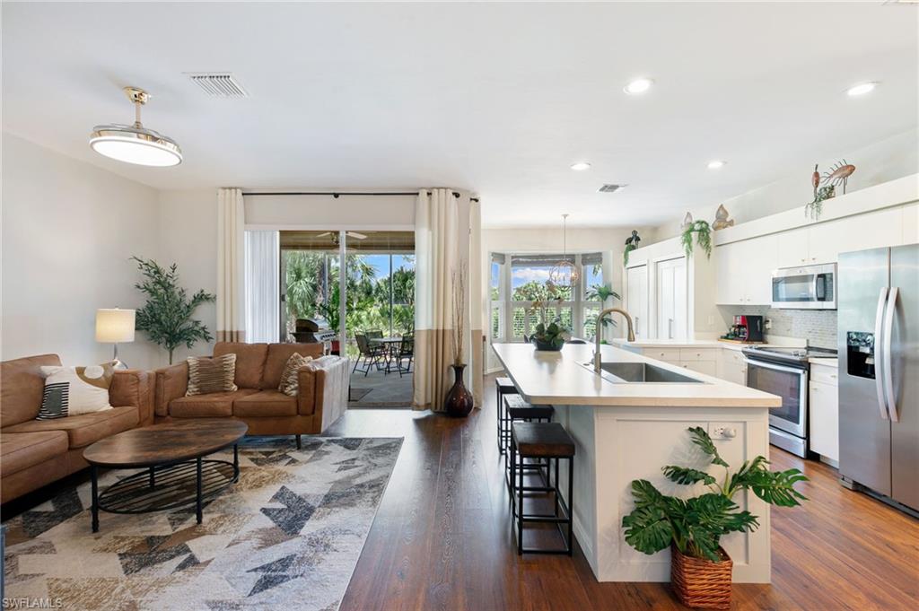 21445 Knighton Run Estero, FL 33928 - Photo 9 of 48 a living room with furniture potted plant and a large window