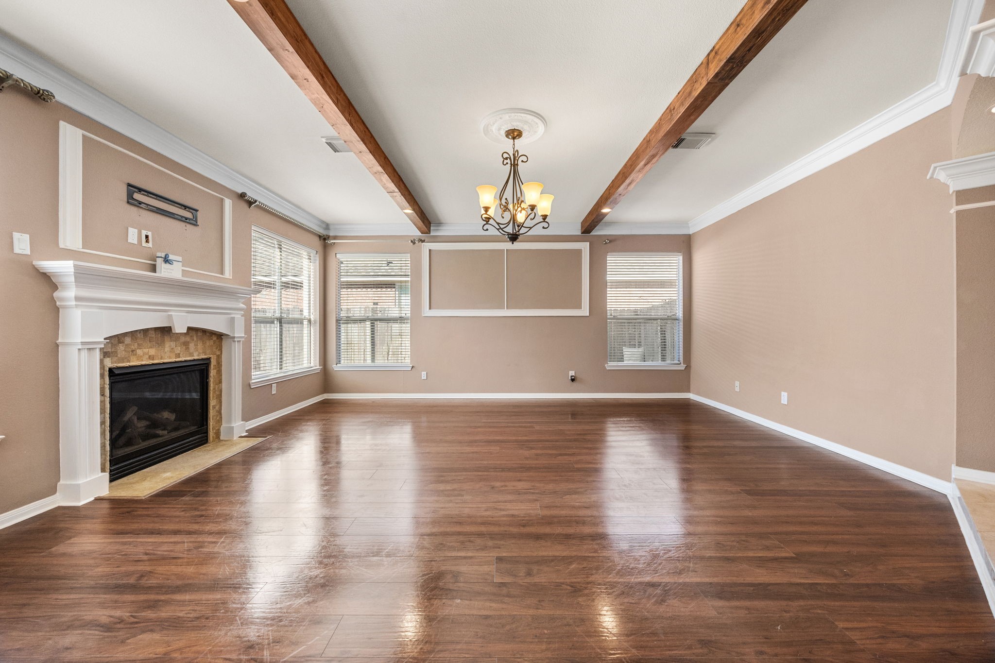 20407 Spring Rose Drive Katy, TX 77450 - Photo 11 of 33 Here's another angle of the expansive living room with the wood beamed ceiling and gas log fireplace to the left.