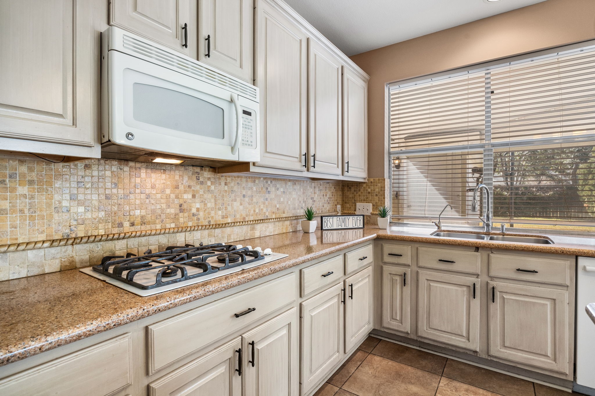 20407 Spring Rose Drive Katy, TX 77450 - Photo 16 of 33 The kitchen is designed for both everyday meals and entertaining, featuring a gas cooktop for precision cooking.
