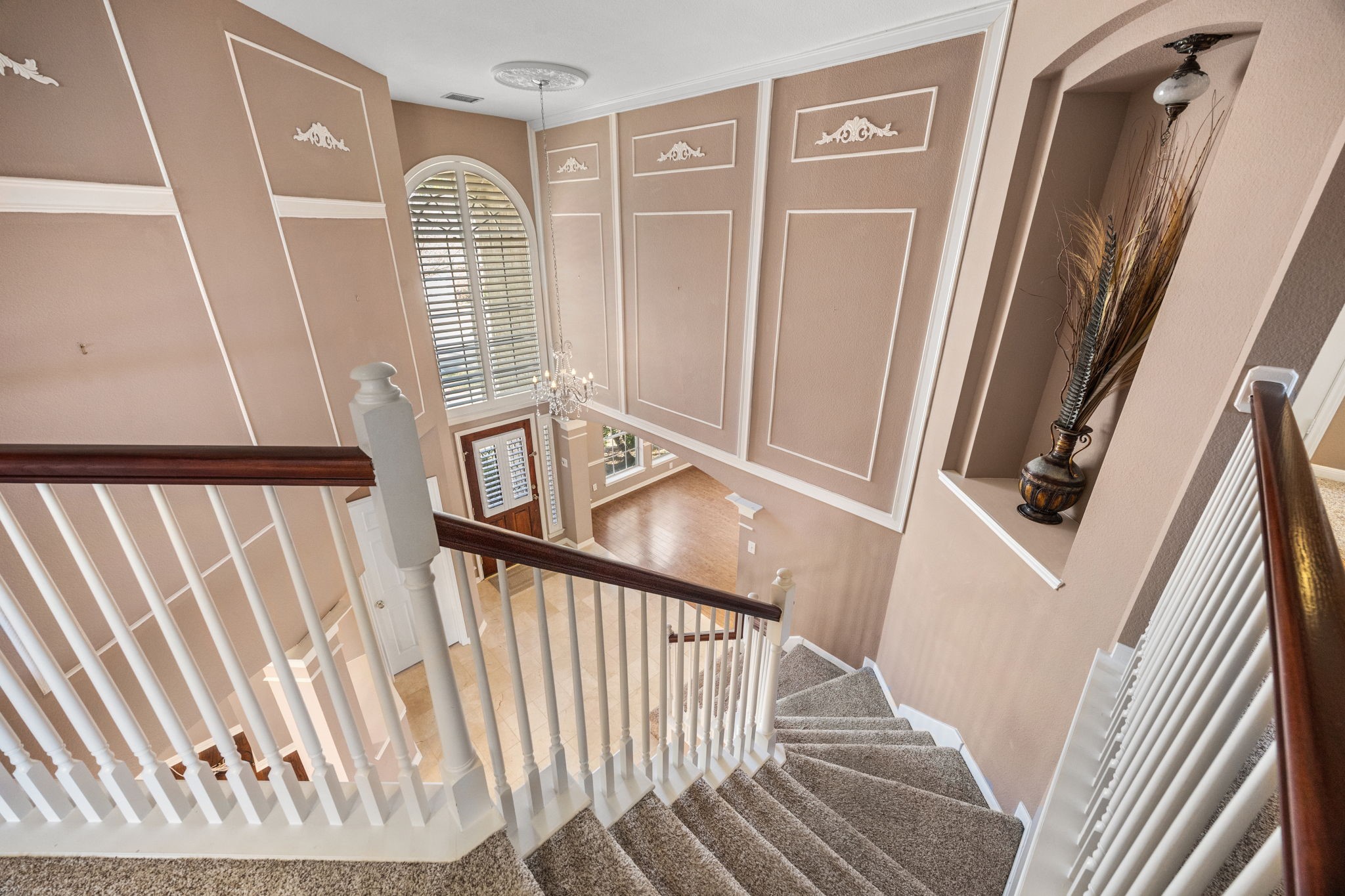20407 Spring Rose Drive Katy, TX 77450 - Photo 18 of 33 From upstairs, enjoy an elegant view of the entryway, showcasing the home’s high ceilings and open layout. This perspective highlights the architectural design and creates a sense of spaciousness throughout the home.
