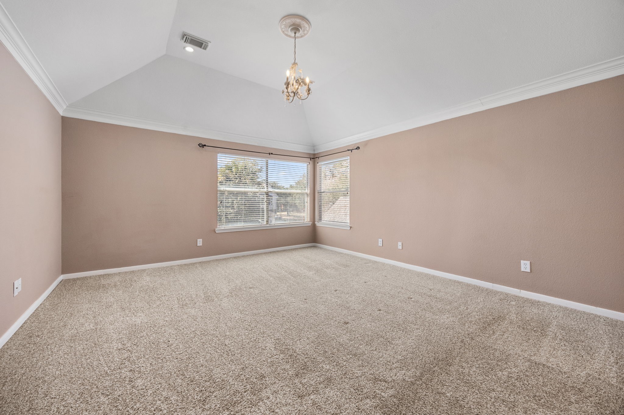 20407 Spring Rose Drive Katy, TX 77450 - Photo 19 of 33 The large primary suite offers an abundance of natural light and open space, creating a relaxing retreat with nice carpeting and a private bathroom.