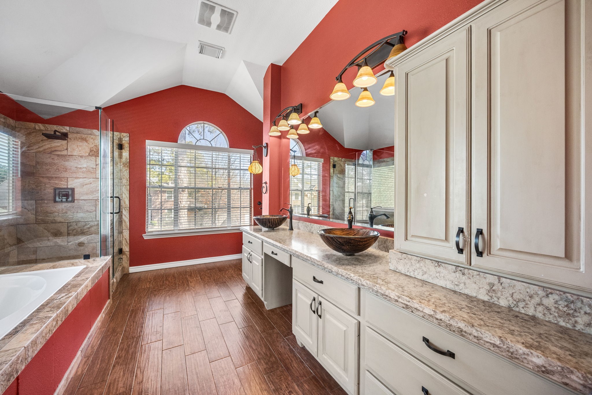 20407 Spring Rose Drive Katy, TX 77450 - Photo 21 of 33 The primary suite bathroom is a seamless extension of the bedroom, offering a spa-like retreat with a jetted tub, separate shower, and plenty of counter space. Dual sinks provide convenience and functionality, making this private bath both elegant and practical.