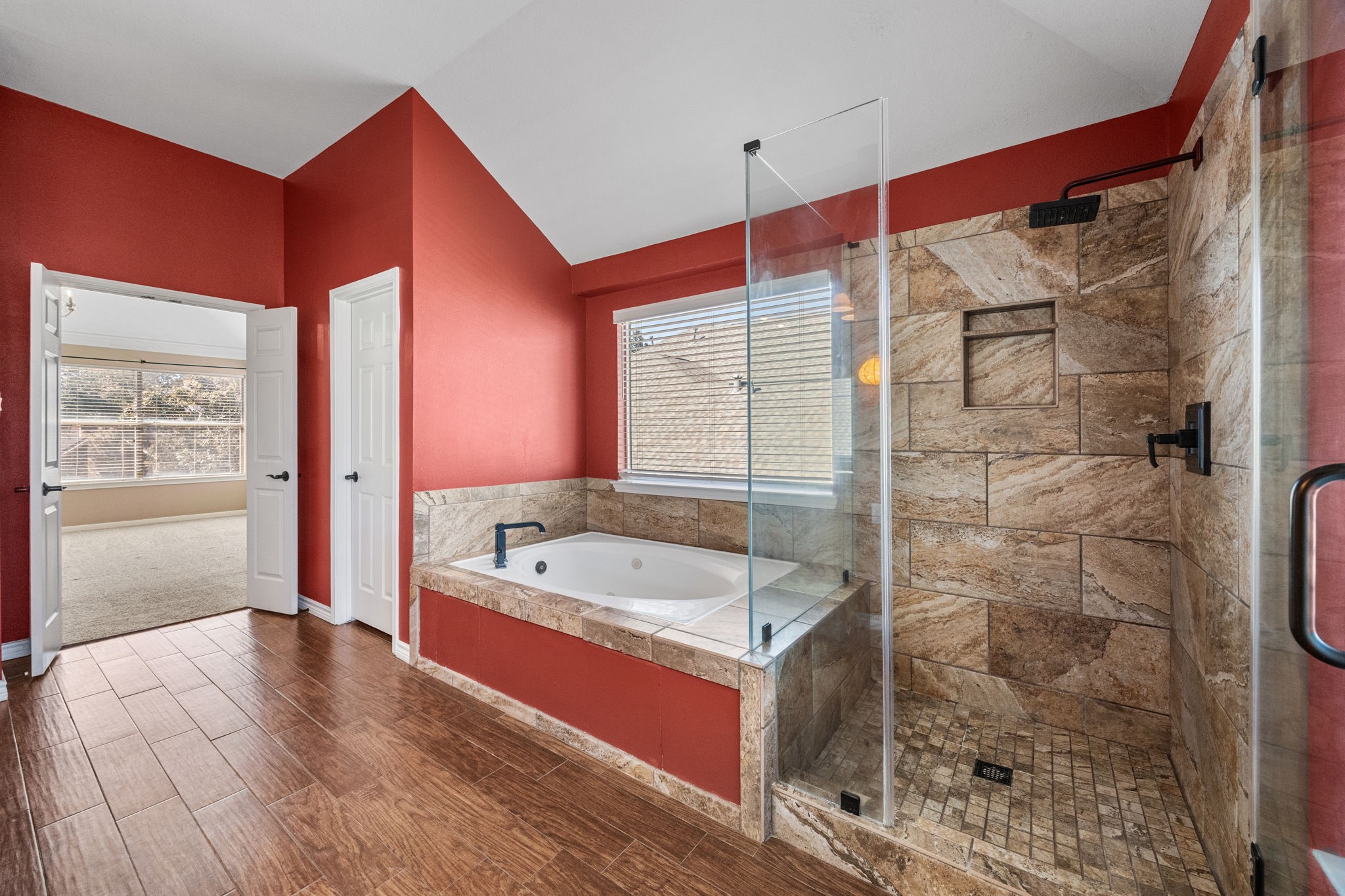 20407 Spring Rose Drive Katy, TX 77450 - Photo 22 of 33 The primary suite bathroom offers a spa-like retreat with a jetted tub and a separate, elegantly tiled shower. Designed for both comfort and style, it provides the perfect balance of relaxation and functionality.