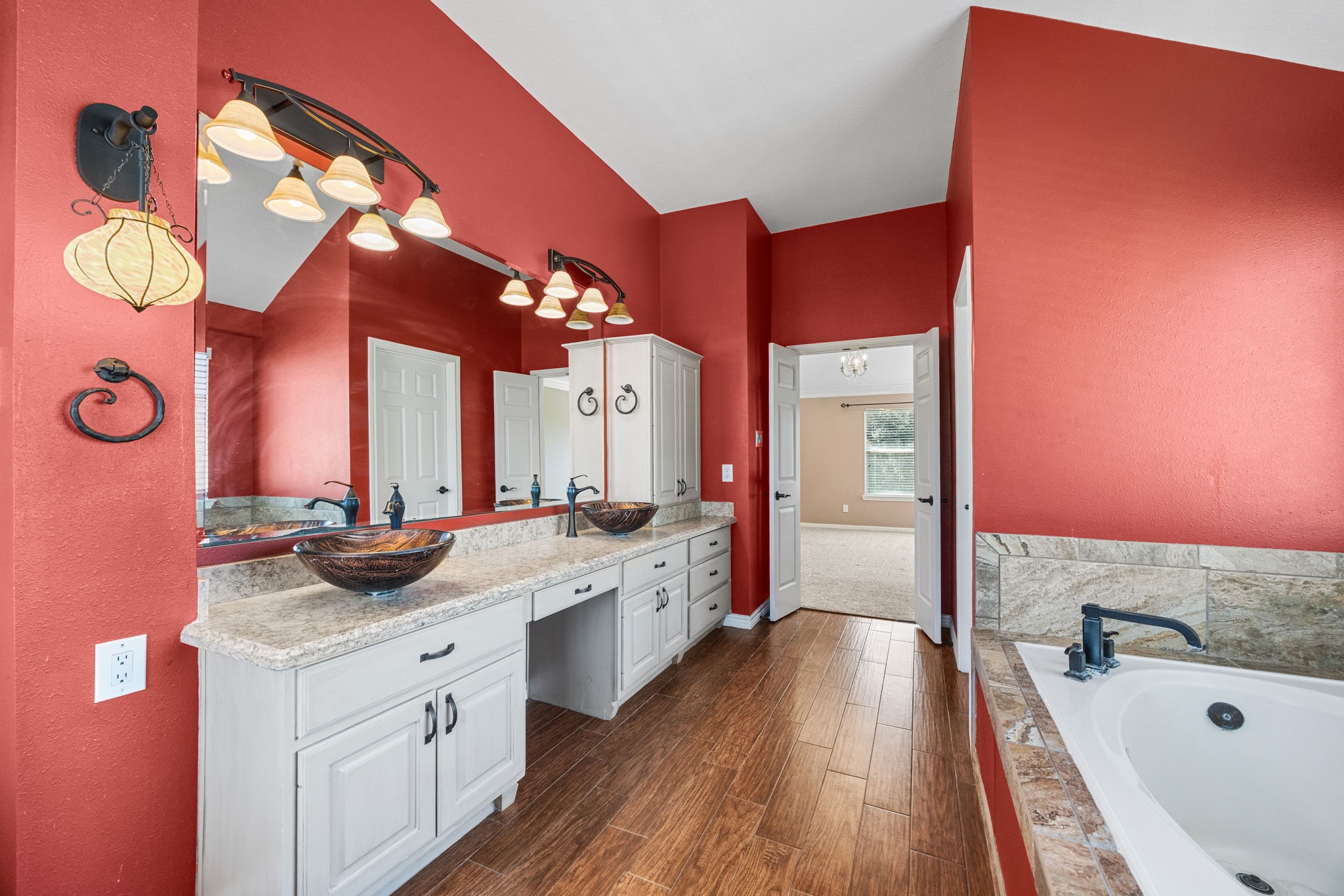 20407 Spring Rose Drive Katy, TX 77450 - Photo 23 of 33 The primary suite bathroom features raised vessel sinks with abundant counter space and gorgeous lighting as well as plenty of cabinets for storage.