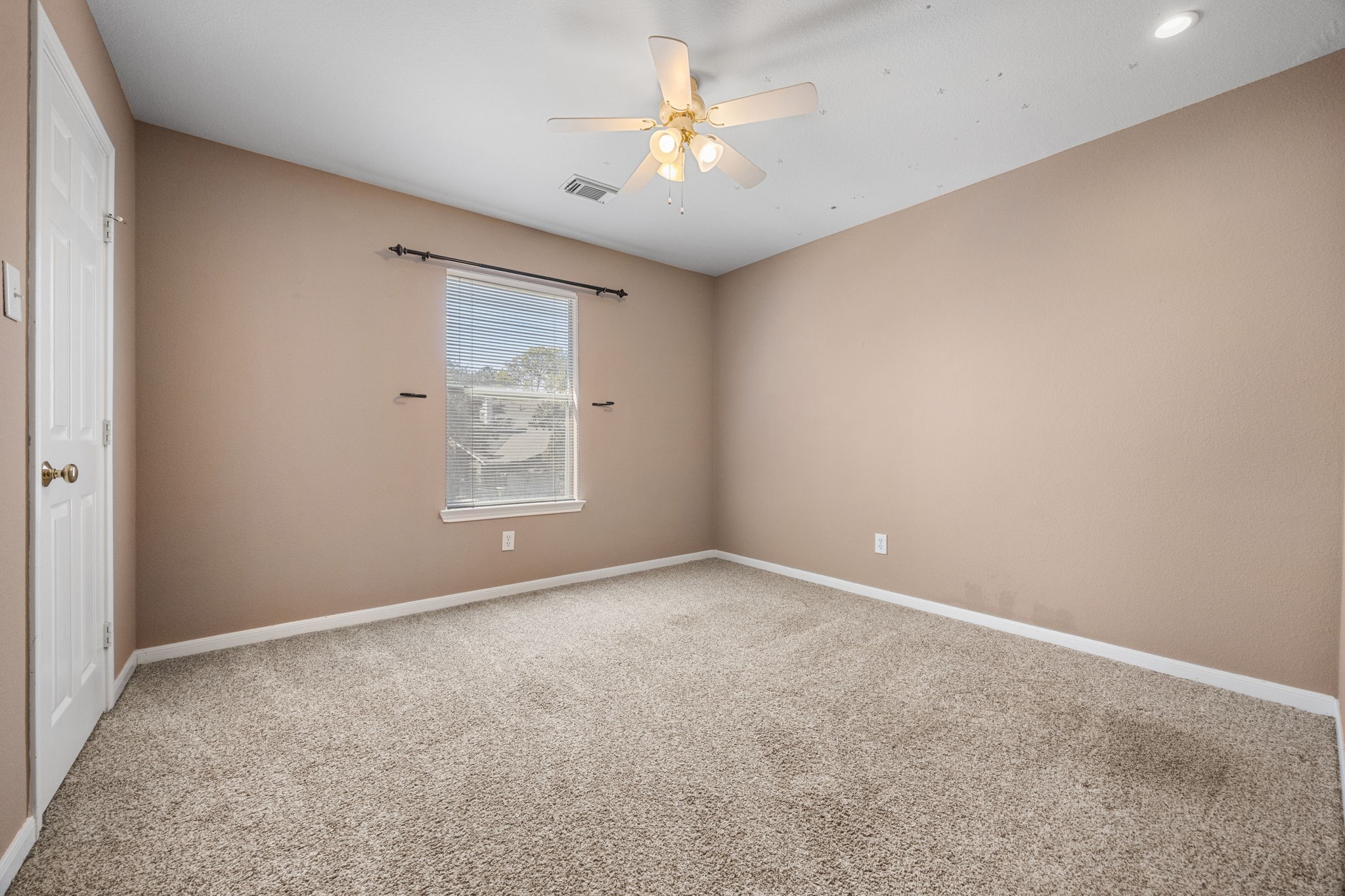 20407 Spring Rose Drive Katy, TX 77450 - Photo 25 of 33 Here is one of the three additional bedrooms upstairs with a walk-in closet and ceiling fan to keep you cool.