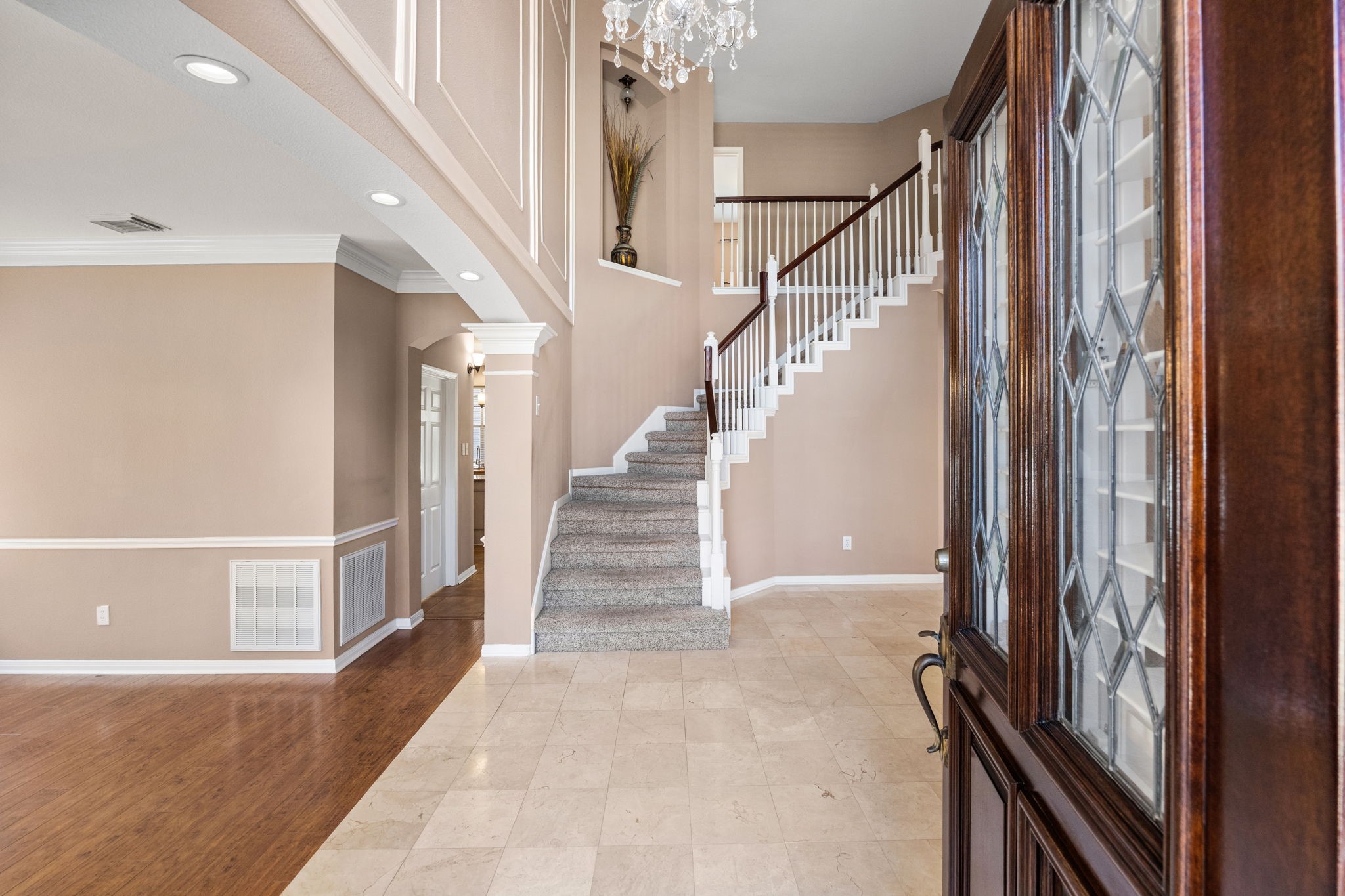 20407 Spring Rose Drive Katy, TX 77450 - Photo 4 of 33 The entryway showcases a sweeping staircase that makes a striking first impression. To the left, a formal dining area offers an elegant space for gatherings, perfectly positioned to complement the home’s open and inviting layout.