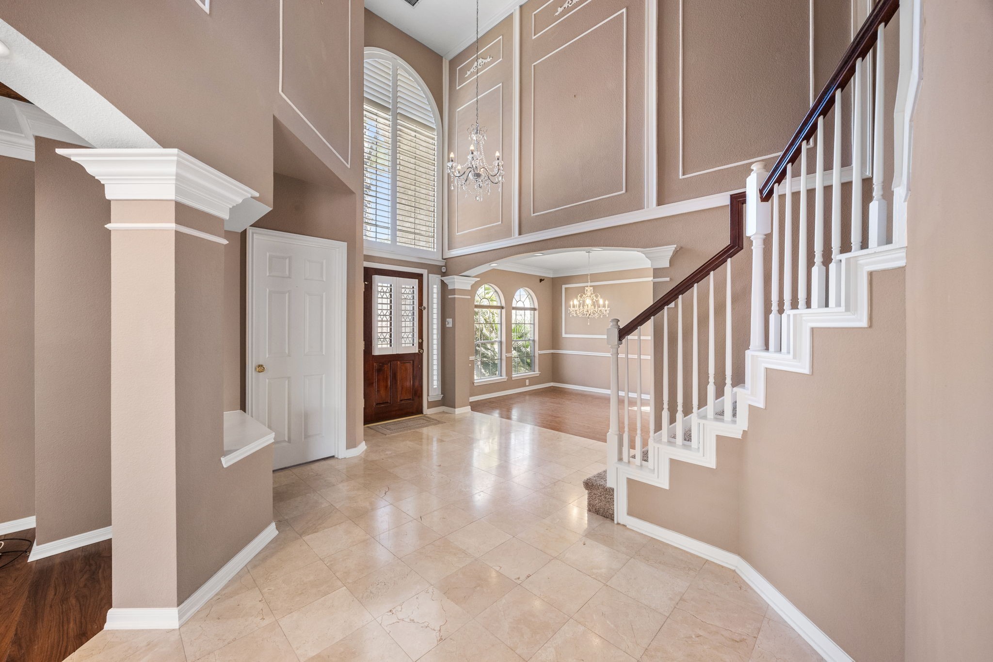 20407 Spring Rose Drive Katy, TX 77450 - Photo 6 of 33 Here's an angle looking at the front door from inside. The transom above the grand front door, allows the natural light to flow into the rooms.