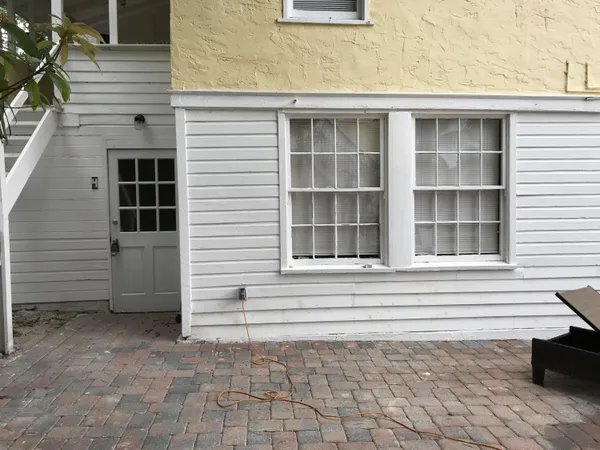 a small white house with a outdoor space