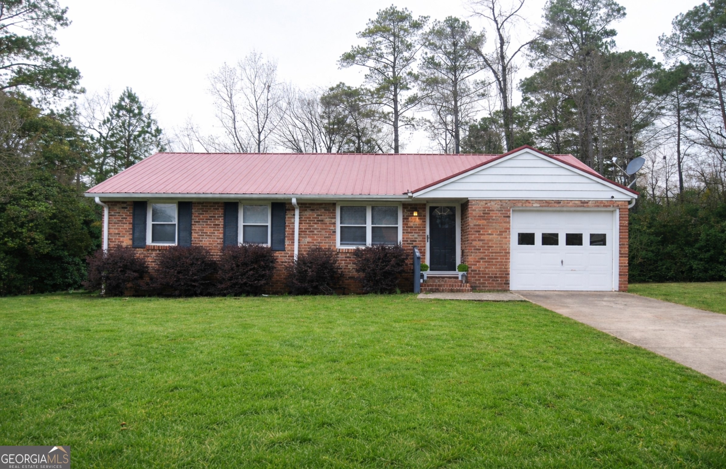 1508 Cloverdale Road Anniston, AL 36207 - Photo 1 of 19 a front view of a house with a garden and trees