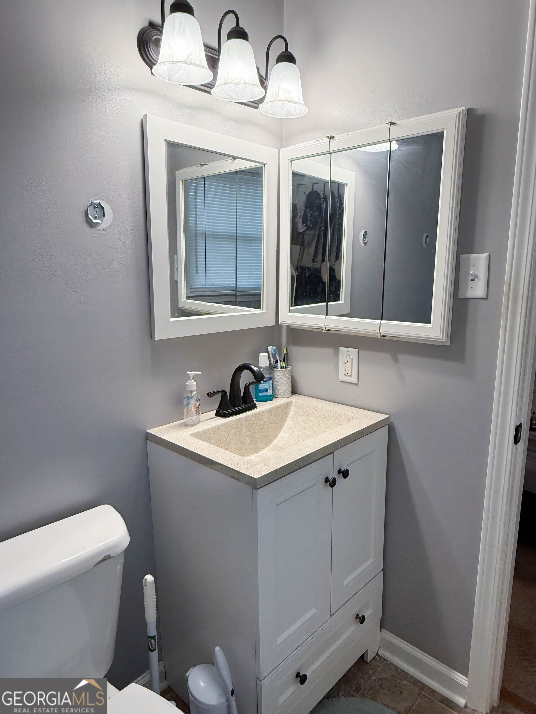 1508 Cloverdale Road Anniston, AL 36207 - Photo 11 of 19 a bathroom with a toilet sink and mirror