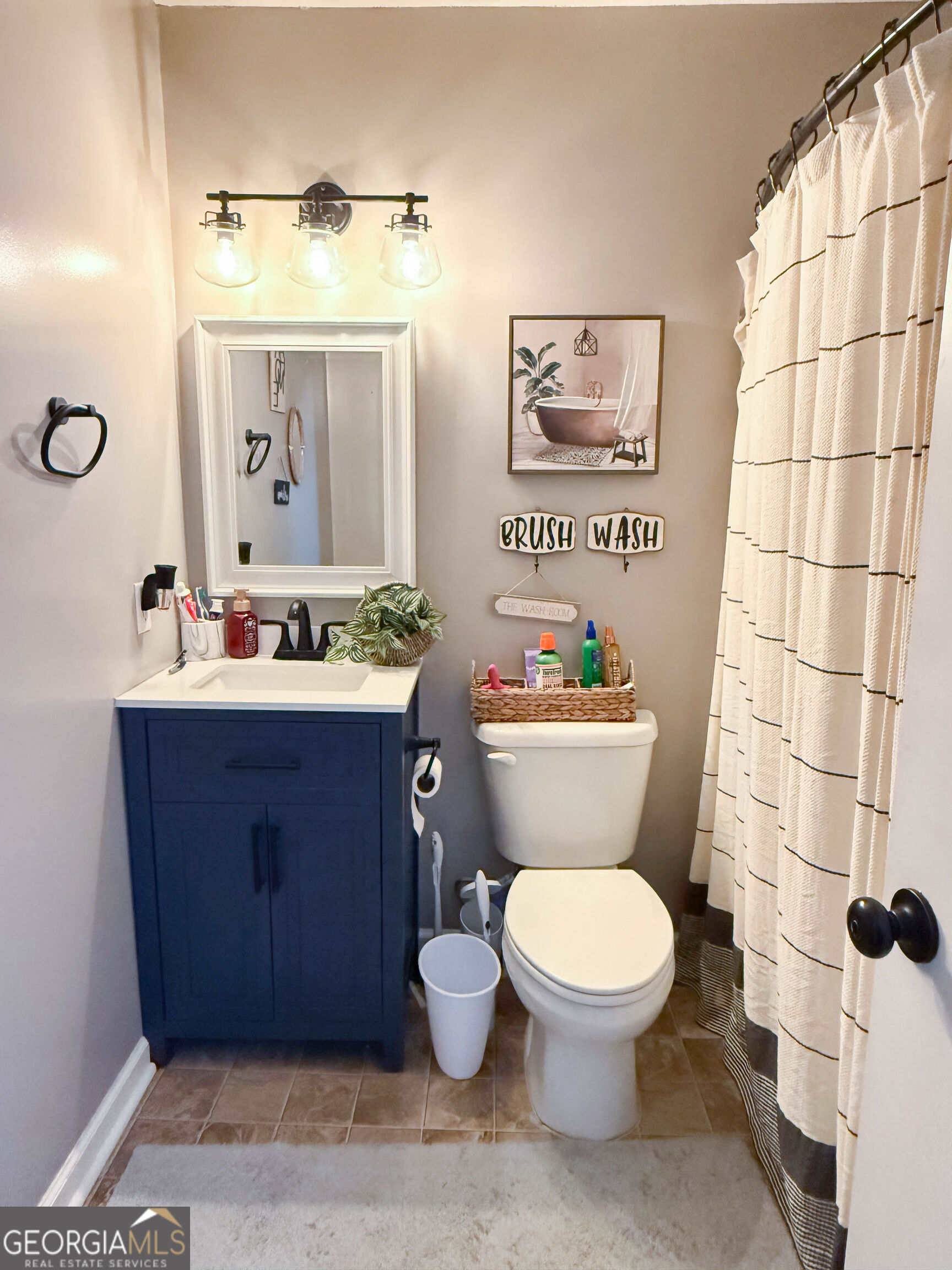 1508 Cloverdale Road Anniston, AL 36207 - Photo 16 of 19 a bathroom with a toilet sink and mirror