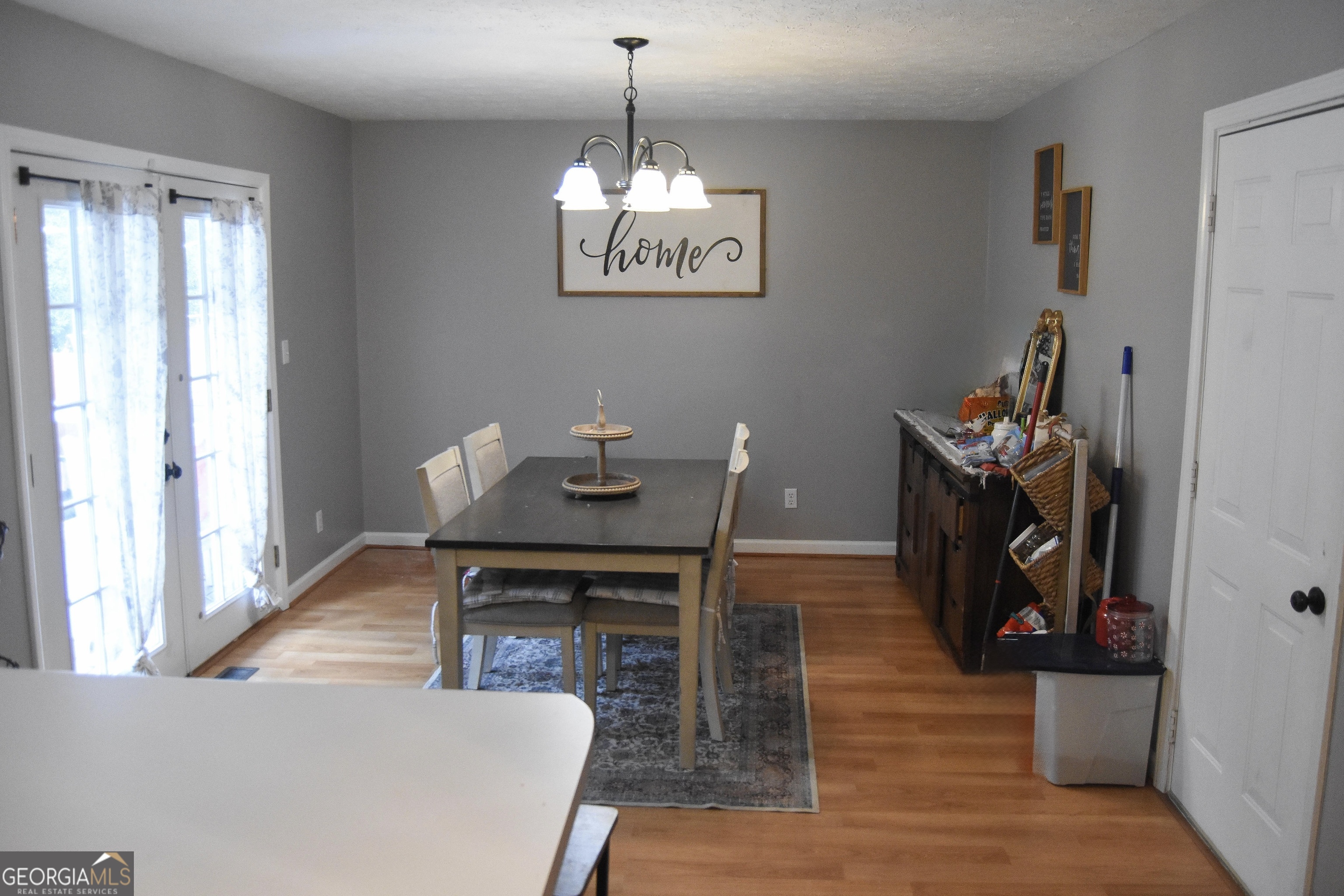 1508 Cloverdale Road Anniston, AL 36207 - Photo 6 of 19 a view of a dining room with furniture wooden floor and a chandelier