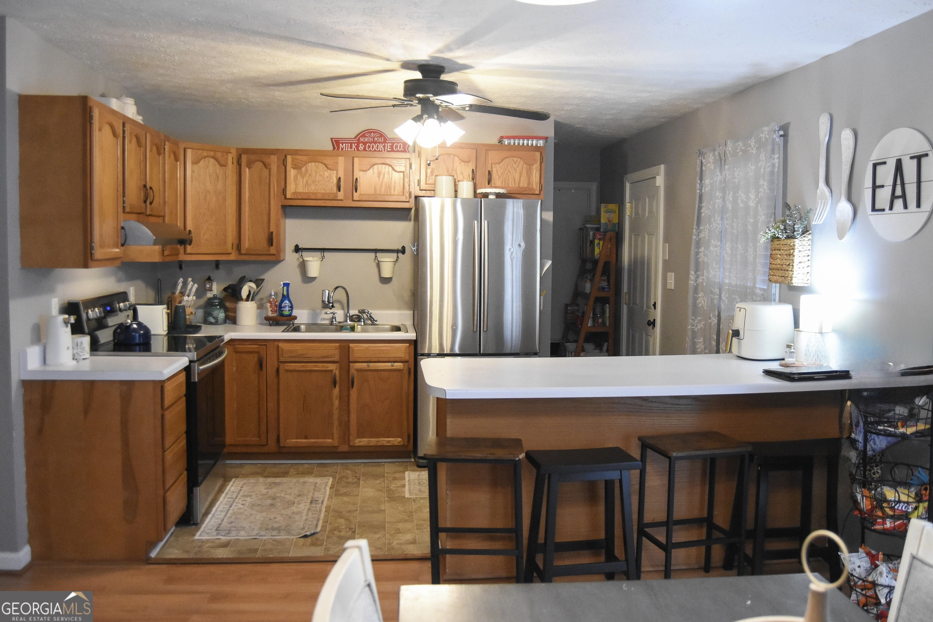1508 Cloverdale Road Anniston, AL 36207 - Photo 7 of 19 a kitchen with a table chairs refrigerator and cabinets