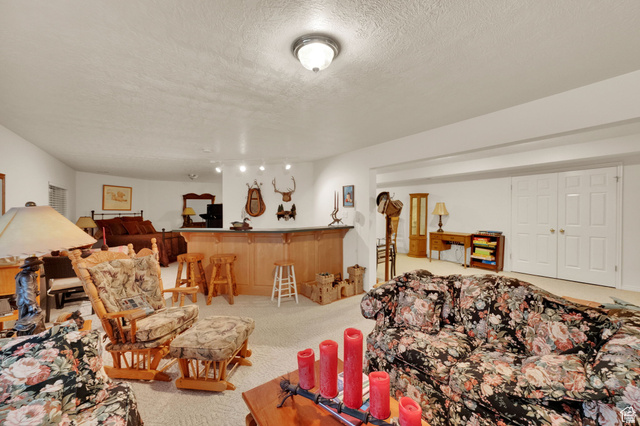 7740 Keswick Road Sandy, UT 84093 - Photo 41 of 74 Finished lower level with a built-in wooden bar, recessed lighting, and carpeted flooring