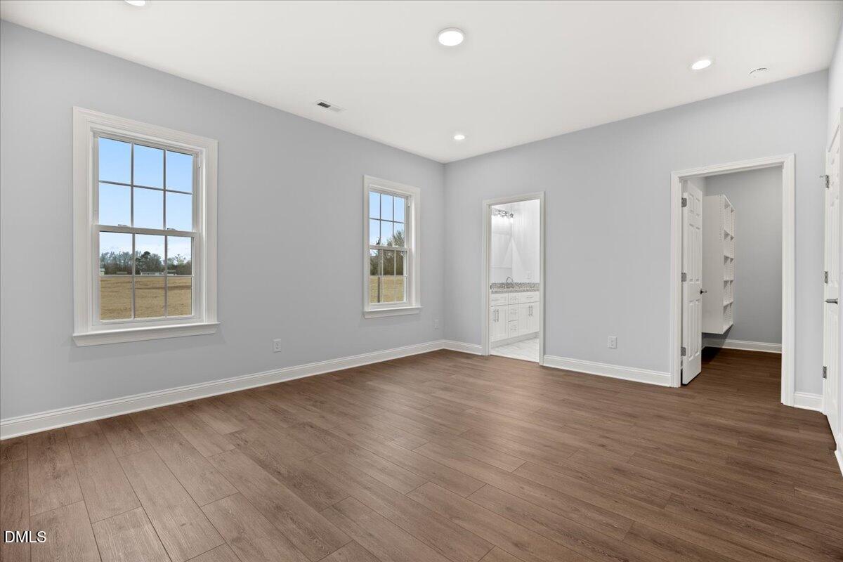 1300 Nick Coley Road Whitakers, NC 27891 - Photo 40 of 47 an empty room with wooden floor and windows
