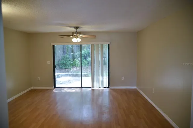 a view of a room with wooden floor and cabinets